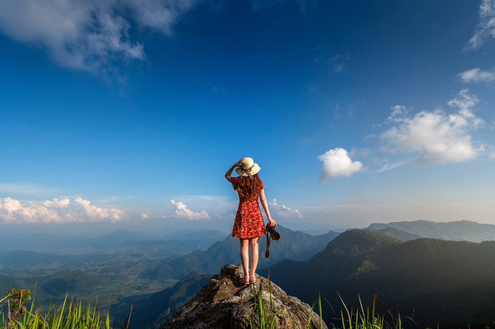 woman hand holding camera standing top rock nature travel concept scaled